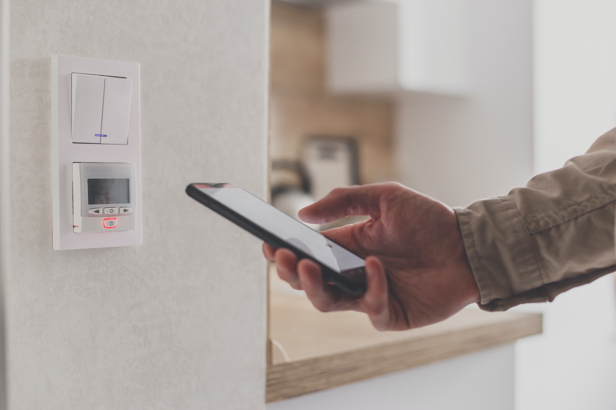 Smartphone connecting to floor heating controller in kitchen