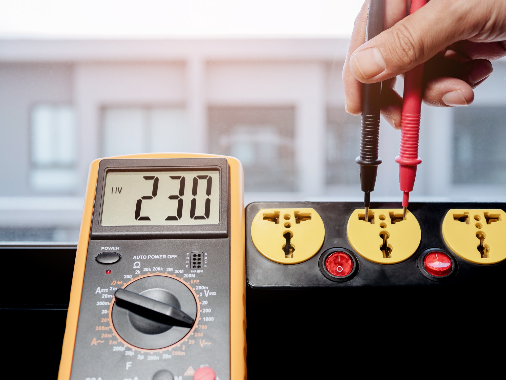 Measure the AC voltage of 230 Volts from the power outlet with a digital meter.